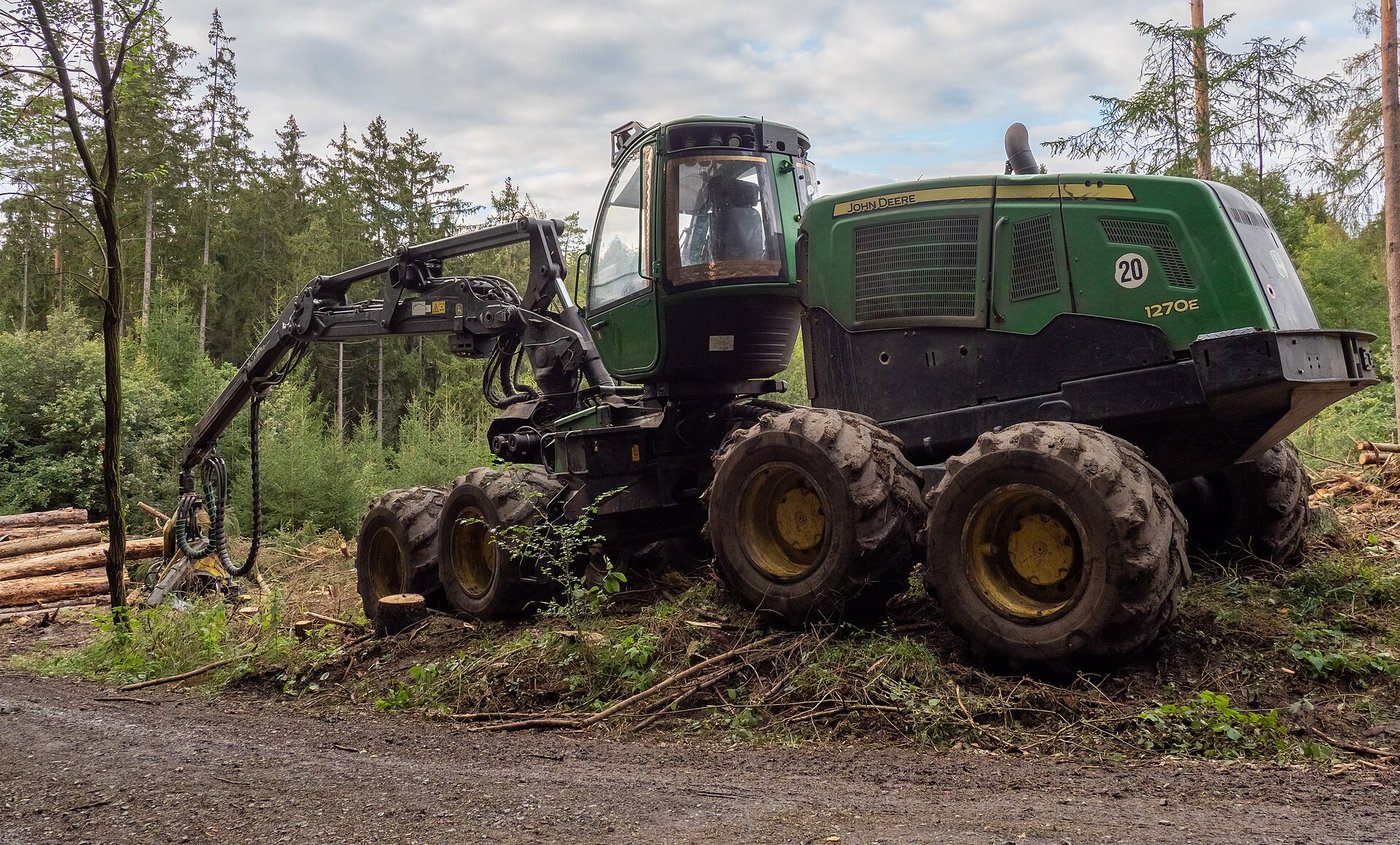 A mechanised harvester working in a forest