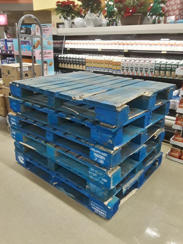 A stack of wooden pallets awaiting reuse